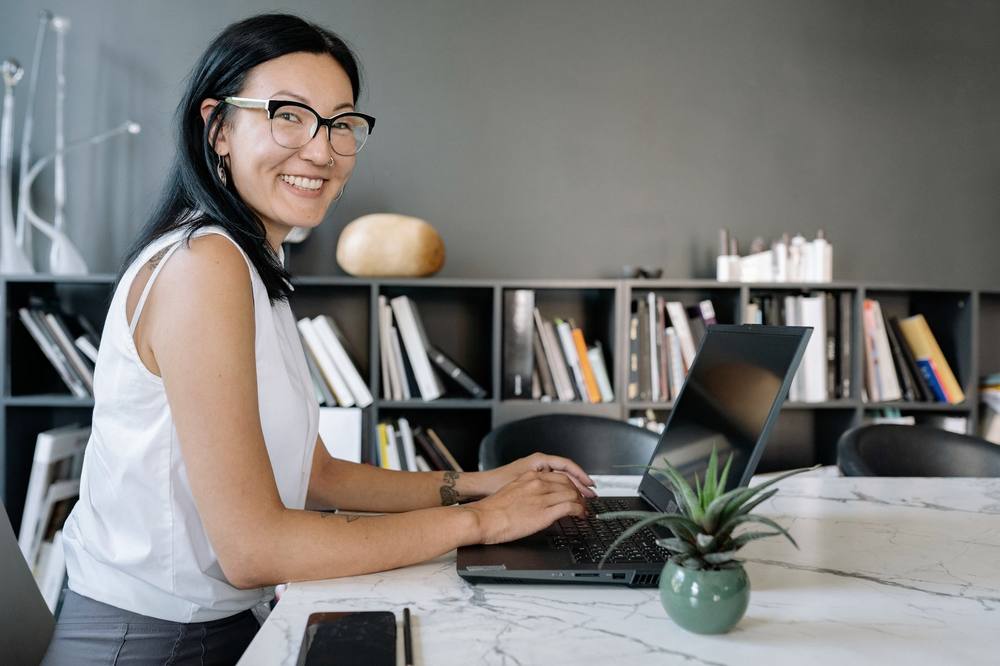 A professional working at a laptop in an office